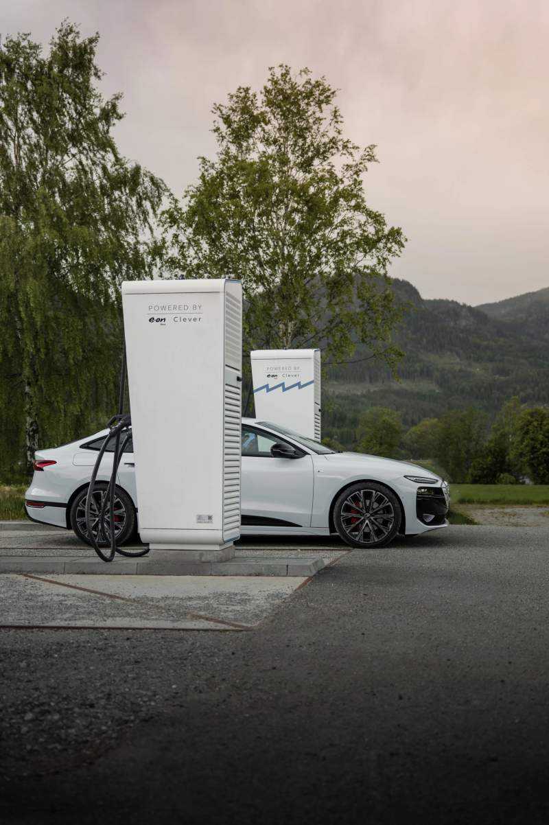 Audi A6 Sportback e-tron w kolorze Glacier white metallic ładuje się przy punkcie ładowania